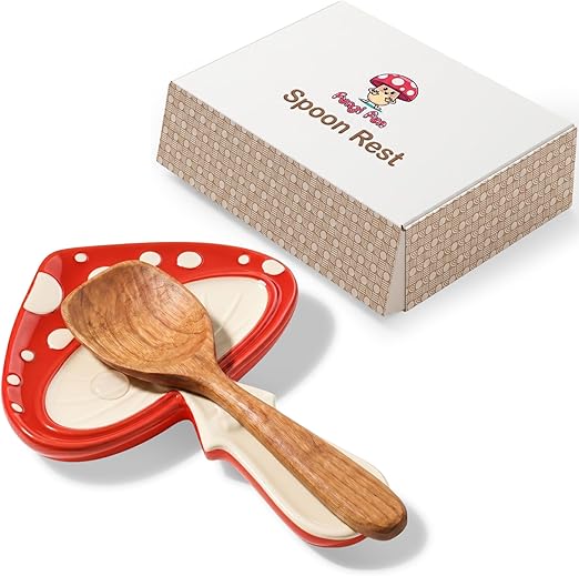 Wooden spoon on a red mushroom-shaped spoon rest with a branded box in the background.