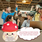 Group of people celebrating with a mushroom plushie and motivational text in an office setting.