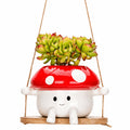 Mushroom-shaped planter with succulents on a white background