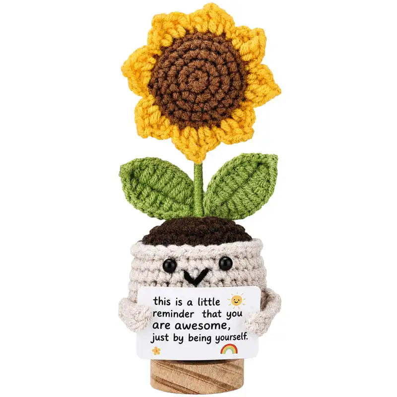 Crocheted sunflower in a pot with a motivational message on a white background