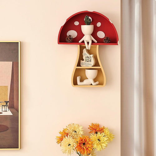 Decorative wall shelf shaped like a mushroom with small figurines and plants on a beige wall.
