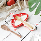 Red and white polka dot spoon rest with wooden spoon on a wooden surface, measurements indicated.