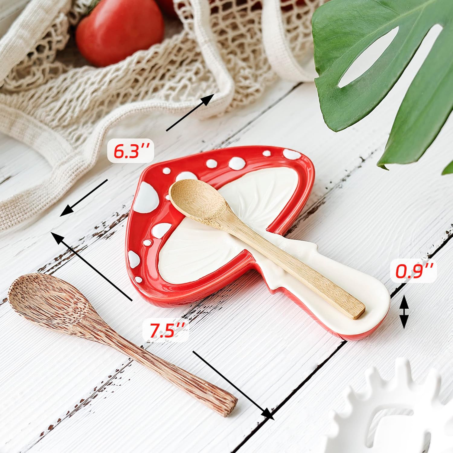 Red and white polka dot spoon rest with wooden spoon on a wooden surface, measurements indicated.