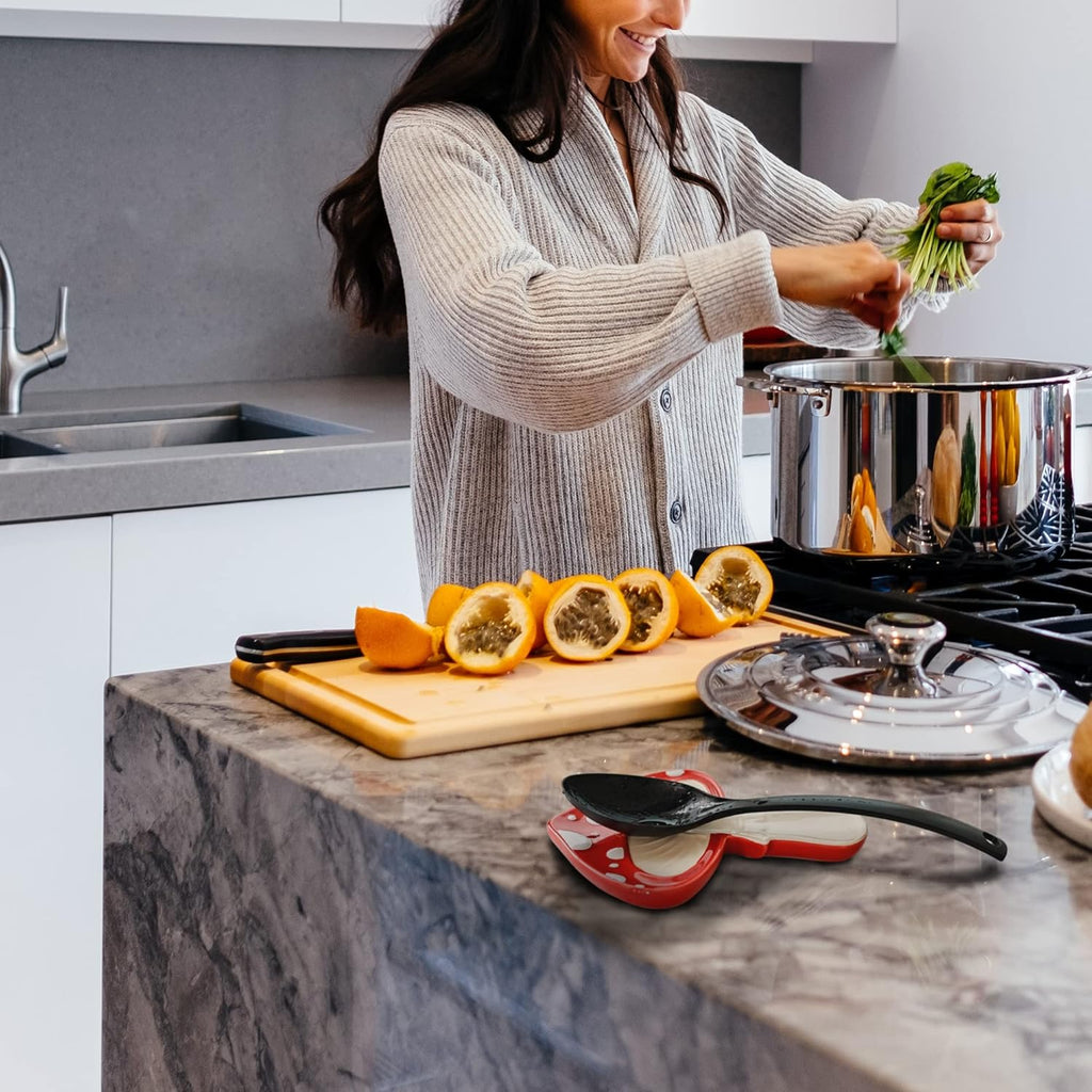 Woman cooking in a kitchen with vegetables and a pot on the stove.