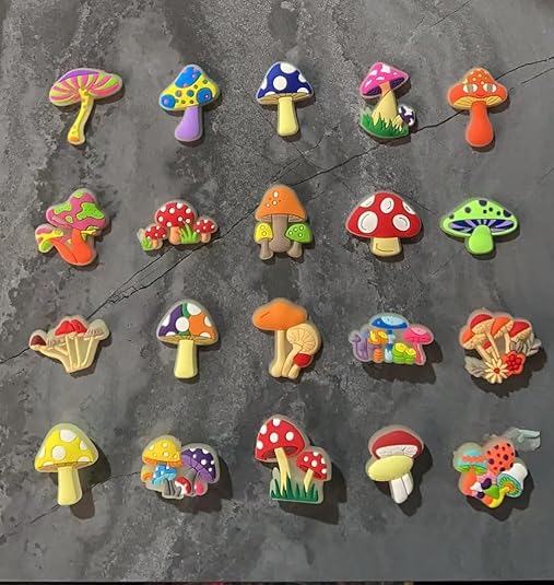 Collection of colorful mushroom-shaped pins on a textured surface
