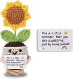 Crocheted sunflower in a pot with a motivational message card on a white background