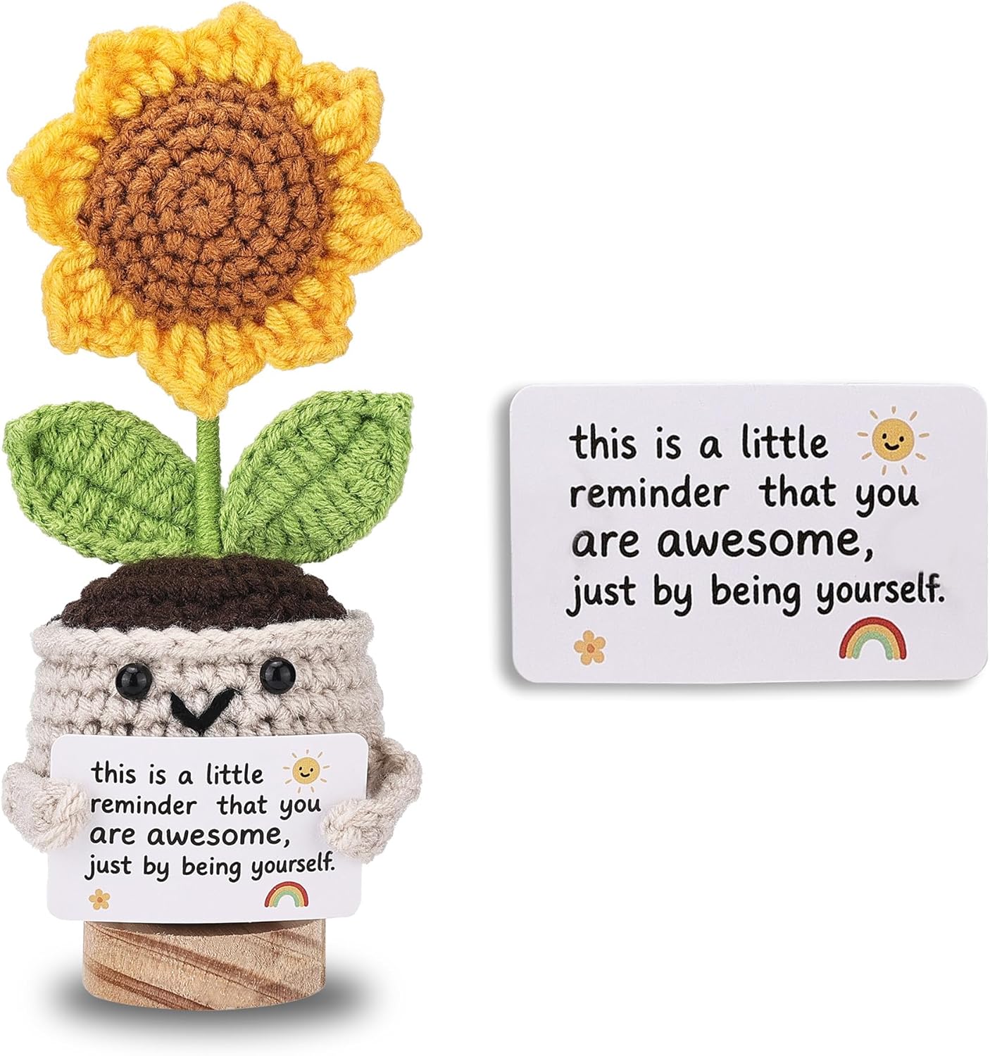 Crocheted sunflower in a pot with a motivational message card on a white background