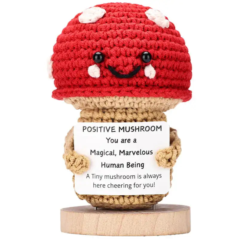 Crocheted mushroom with a motivational message on a white background